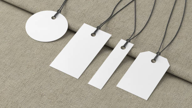 istock White tags of various shapes mockup on fabric background. Side view 1486227203