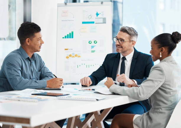 istock Business meeting, planning and teamwork while sharing idea for financial growth and innovation by marketing team discussing graphs and data in boardroom. Diverse colleagues sharing vision and mission 1486229738
