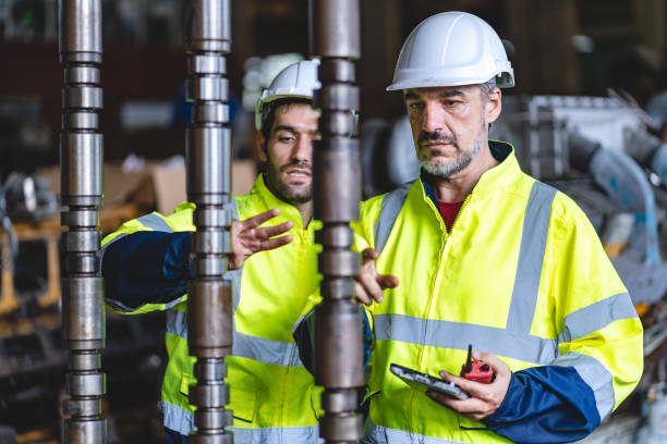 istock professional technician engineer with safety hard hat working to maintenance construction equipment in industrial factory, inspection man having manufacturing occupation job of production technology 1486232068