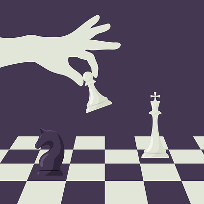 hand holding chess piece and chessboard