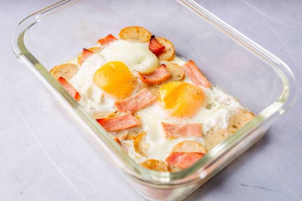 istock Delicious breakfast in a glass dish with bacon and eggs 1486233167