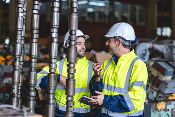 istock professional technician engineer with safety hard hat working to maintenance construction equipment in industrial factory, inspection man having manufacturing occupation job of production technology 1486233447