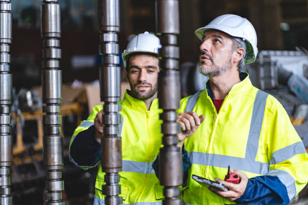 istock professional technician engineer with safety hard hat working to maintenance construction equipment in industrial factory, inspection man having manufacturing occupation job of production technology 1486233456