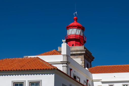 Cascais, Portugal-October 2022; Low angle view of the buildings and light of the Cabo Raso Lighthouse in the Fort of Sao Bras of Sanxete against a clear blue sky