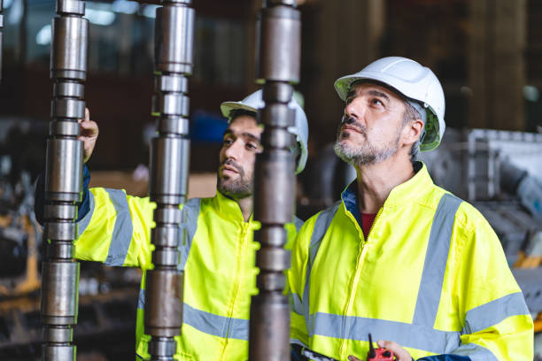 istock professional technician engineer with safety hard hat working to maintenance construction equipment in industrial factory, inspection man having manufacturing occupation job of production technology 1486234196