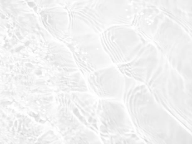 istock White water with ripples on the surface. Defocus blurred transparent white colored clear calm water surface texture with splashes and bubbles. Water waves with shining pattern texture background. 1486234223