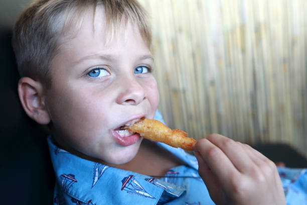 istock Child eating battered shrimp 1486238474