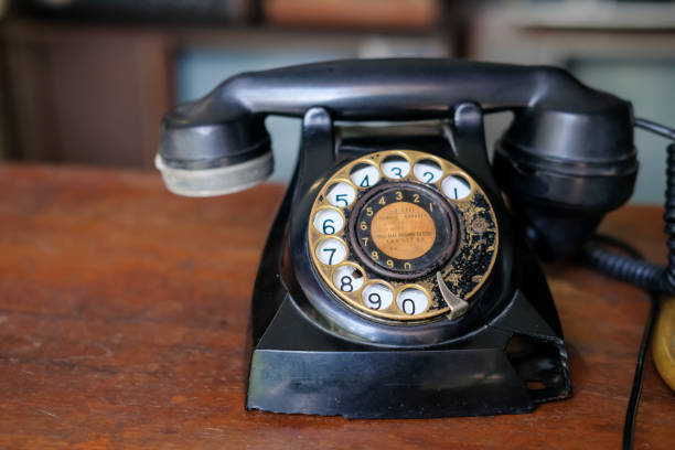 istock old telephone on wooden table, vintage 1486238855