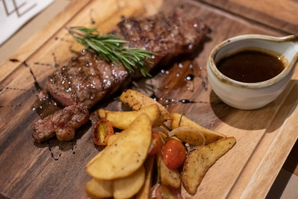 istock Medium rare meat on plate with sauce and fries 1486238906