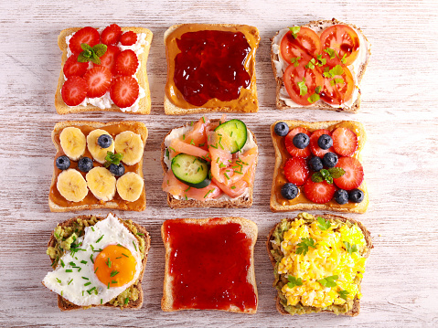 Selection of breakfast toasts with different toppings - savory and sweet. Sandwich, toasts mix, breakfast or brunch, concept