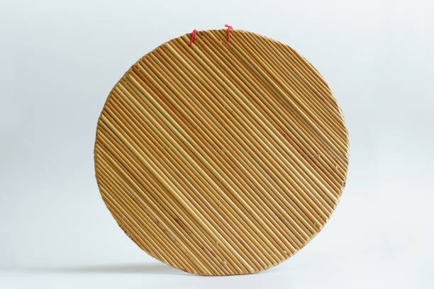handmade round pot cover, which can be used as a table mat. straw mat - seam macro rough striped imagens e fotografias de stock