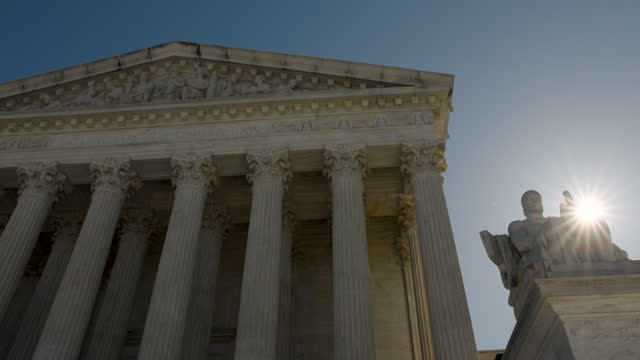 Sun Rising Over Statue At U.S. Supreme Court Building In Washington D.C.