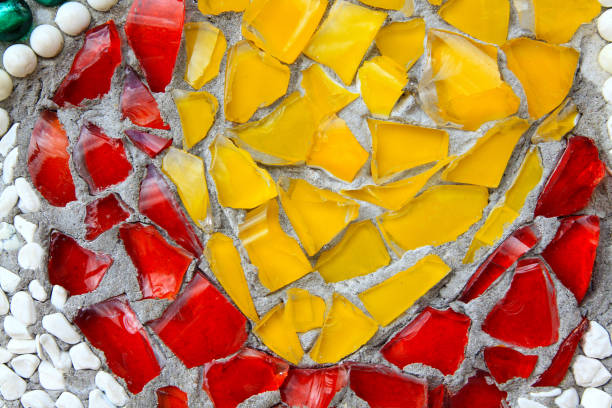 istock Yellow and red bottle cracked or broken with white gravel on wall for background 1486258721