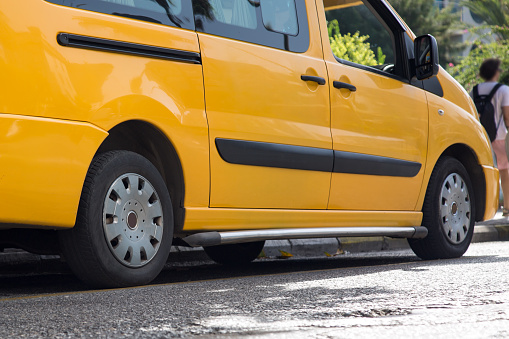 Yellow minibus, taxi bus in the parking lot.