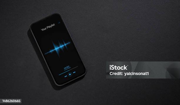Smartphone With Music Player App Open On Screen On Dark Gray Background Stock Photo - Download Image Now