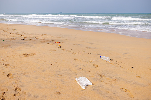 Trash been washed ashore from the Indian Ocean on the tropical beach north of Trincomalee in the Easter Province in Sri Lanka