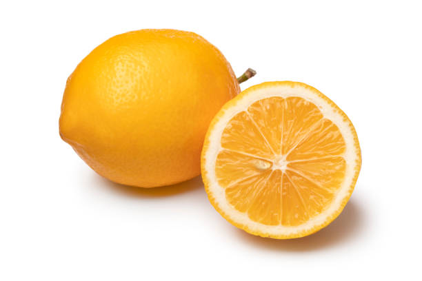 Whole and halved fresh Meyer lemon close up on white background