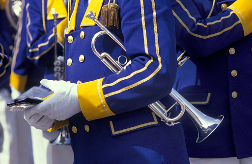 Wating musician with a trumpet under his arm in a uniform close up