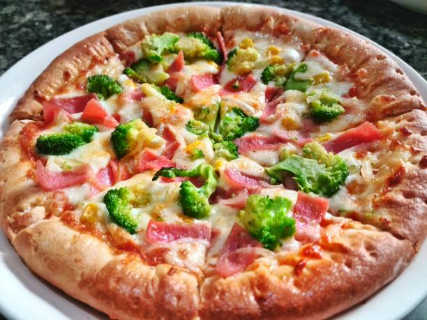 Ham, Broccoli Cheese Pizza Dish High Resolution Stock Photo stock photo