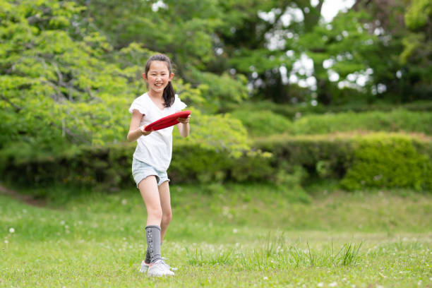istock girl playing with flying disc 1486286514