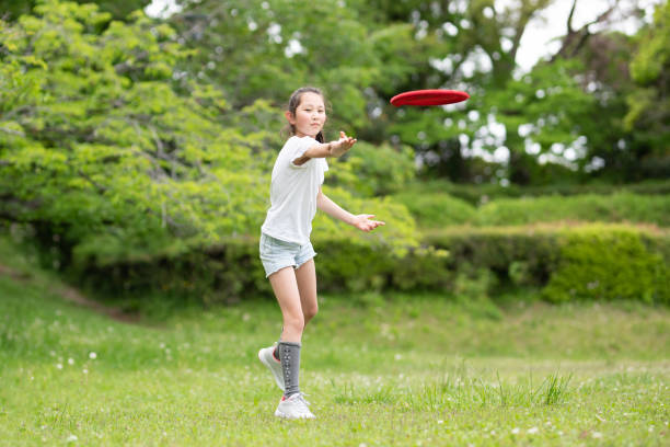 istock girl playing with flying disc 1486286515
