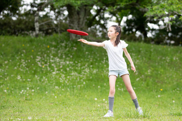 istock girl playing with flying disc 1486286516