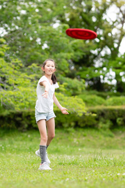 istock girl playing with flying disc 1486286520