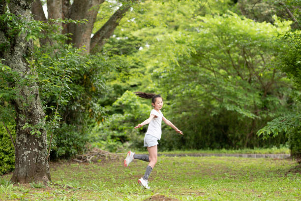 istock girl playing in the forest 1486286530