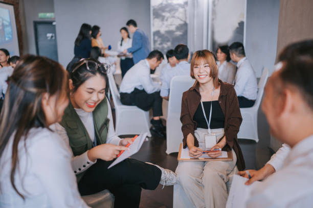 istock Team building Asian workshop participants in small group discussion, brainstorming during business workshop class 1486286600