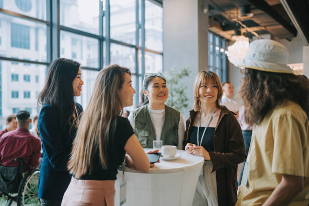 istock Asian young professionals having a casual chat after successful conference event 1486286721