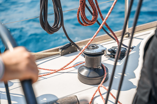 Voyage race sail on professional sport sea yacht. Yachting summer vacation cruise . Captain yachtsman sailing. Sails on mast. Ocean ship boa travel. Enjoy trip on sailboat front deck. Training school.