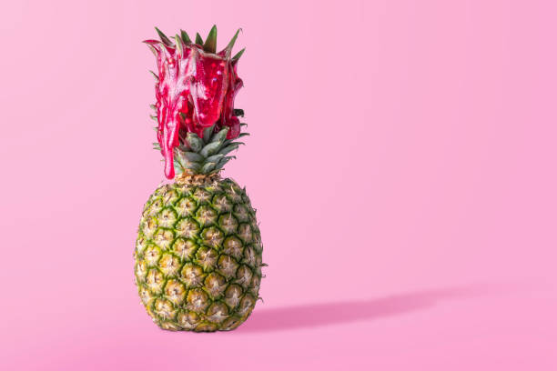 istock Creative fruit concept. Pineapple on a pink background doused in red slime with balloons. 1486296692