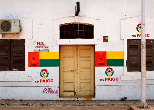 Bissau, Guinea-Bissau, West Africa: colonial building with legislative election campaign for the PAIGC political party (symbol, flag, poster), African Party for the Independence of Guinea and Cape Verde.