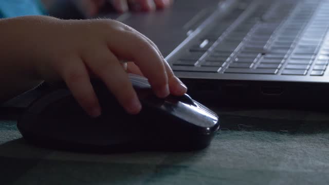 toddler hand clicking on laptop mouse, Close-up