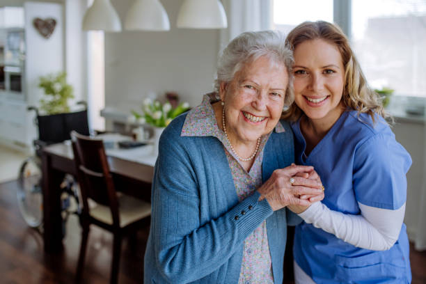 istock Young nurse hugging her senior woman client. 1486314851