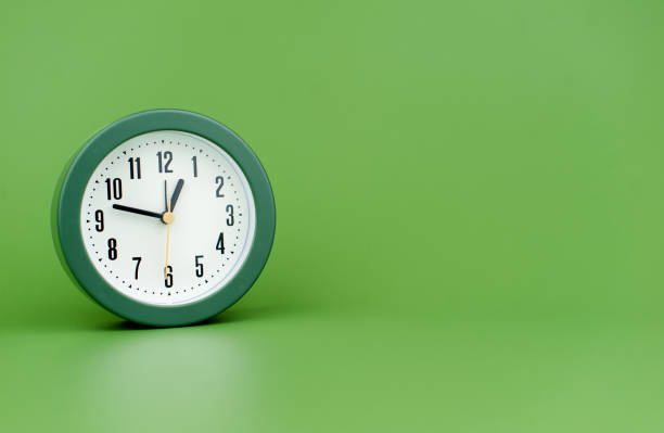istock clock precious time alarm clock on green background concept of time working with time 1486319347