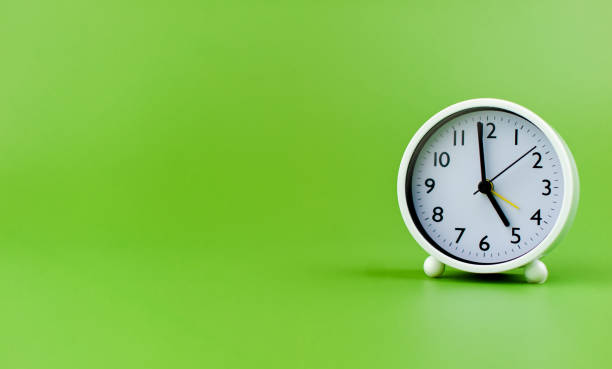 istock clock precious time alarm clock on green background concept of time working with time 1486319358