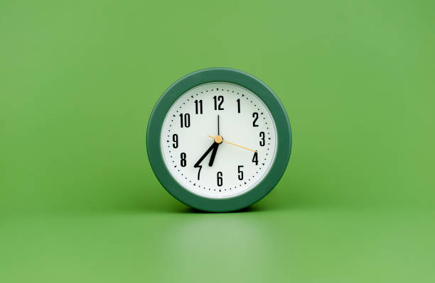 istock clock precious time alarm clock on green background concept of time working with time 1486319445