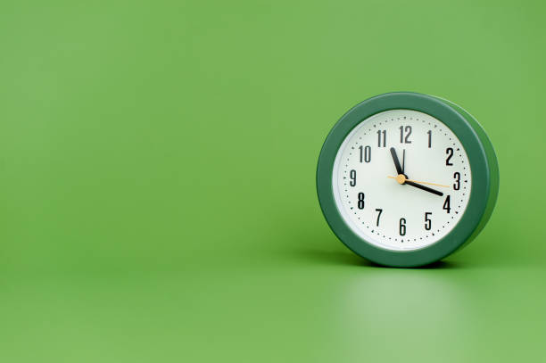 istock clock precious time alarm clock on green background concept of time working with time 1486319448