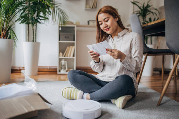 istock Woman has new robotic vacuum cleaner 1486323890