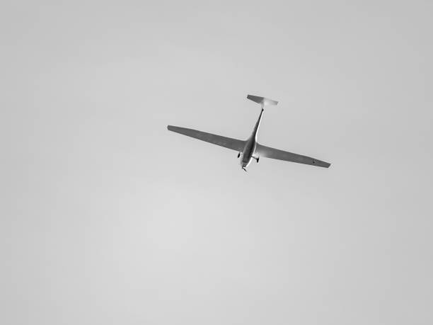 istock Glider with propeller flying in gray sky 1486328104