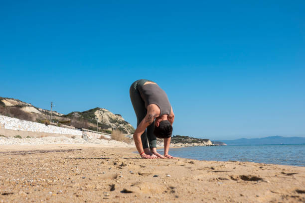 istock Woman practising yoga on the beach 1486330629