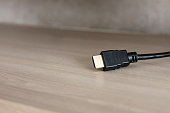 HDMI cable connector on woord background. Home interior
