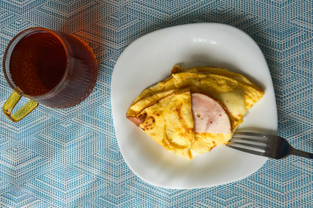 chicken egg omelet with ham and cheese. food for breakfast. background for the design