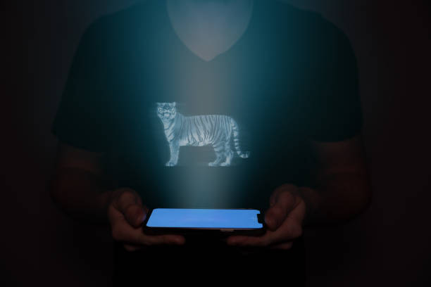 istock A young man from the future holds a smartphone onto which a tiger is projected. Future technology. 1486335018