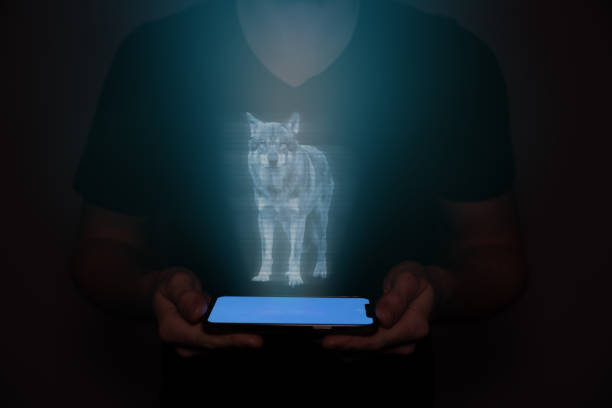 istock A young man from the future holds a smartphone onto which a wolf is projected. Future technology. 1486335030