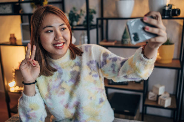 istock Woman using smart phone at home 1486336930