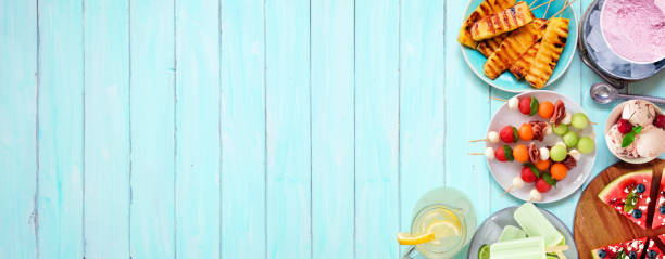 istock Refreshing summer food side border on a blue wood banner background 1486338748