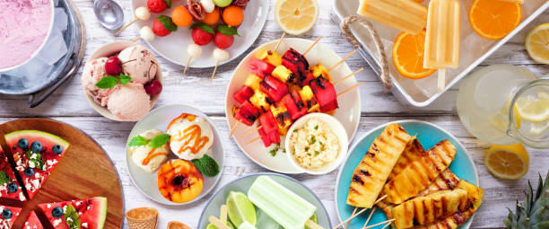 istock Refreshing summer food table scene, above view on a white wood banner 1486338895