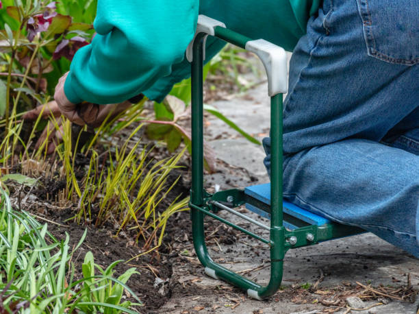 Senior man using garden kneeler while doing gardening